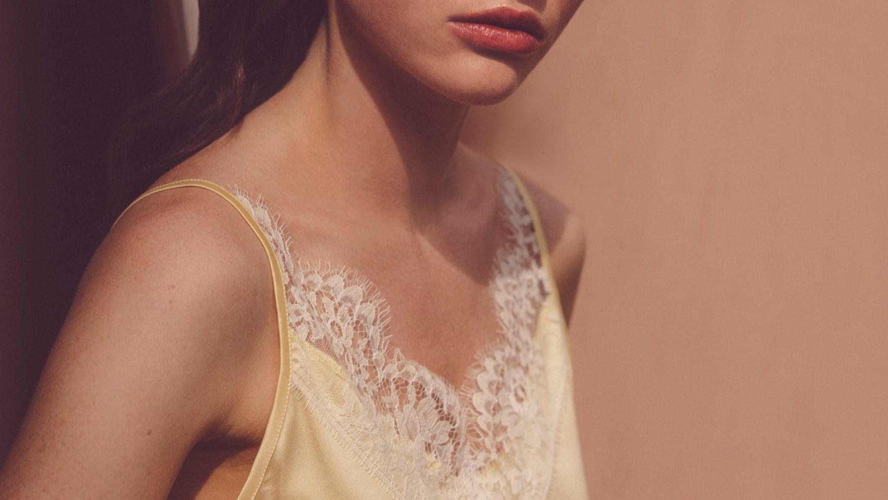 beautiful model woman wearing silk yellow camisole with pretty lace trim